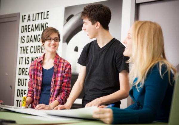 Young men and women working together in a classroom