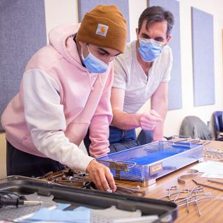 Two people sorting medical tools