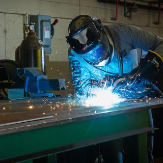 A person doing welding. 