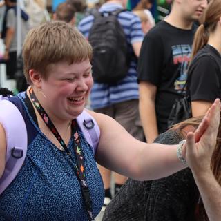 a student high fives someone off camera