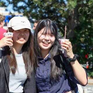 two students hold up snow cones