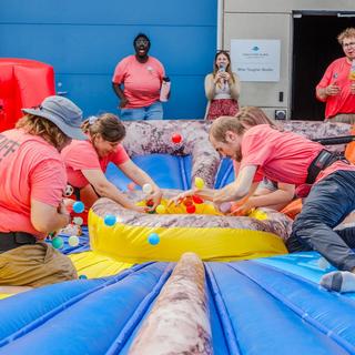students play a hungry hungry hippo inflatable game
