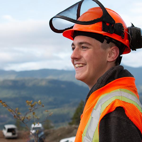 Smiling young man wearing safety gear.
