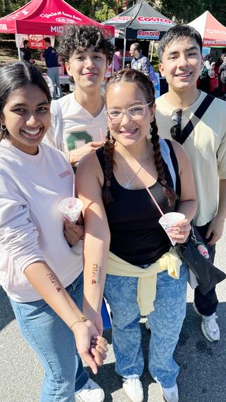 a group of students show off snow cones and VIU tattoos