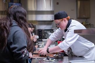 VIU Culinary student helping with a pop-up class