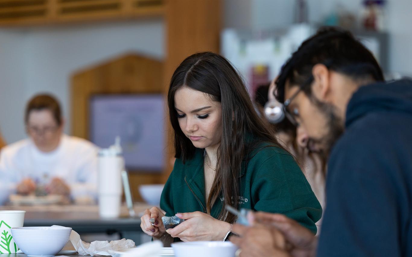 Indigenous VIU students working at a table.