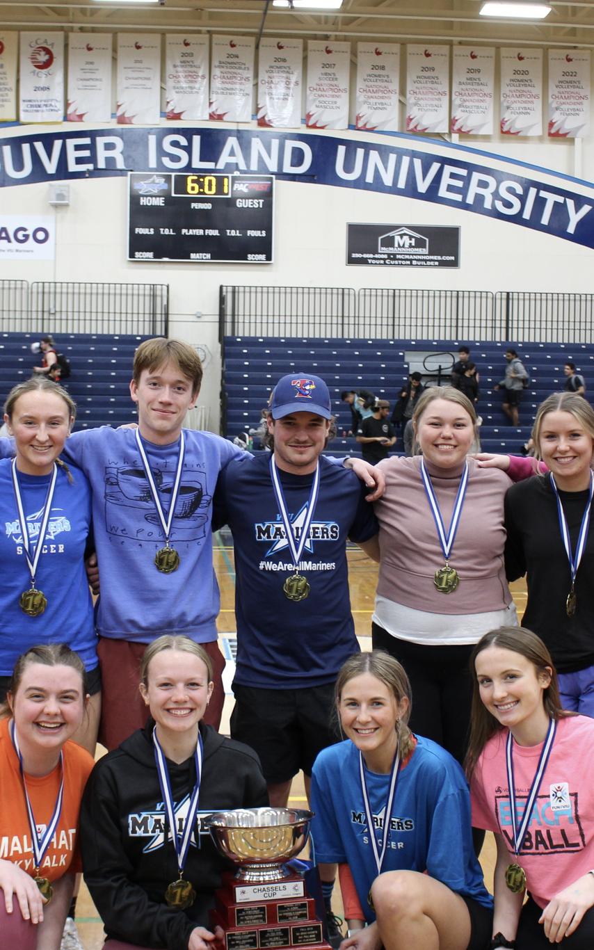 A group of students poses in the VIU gym
