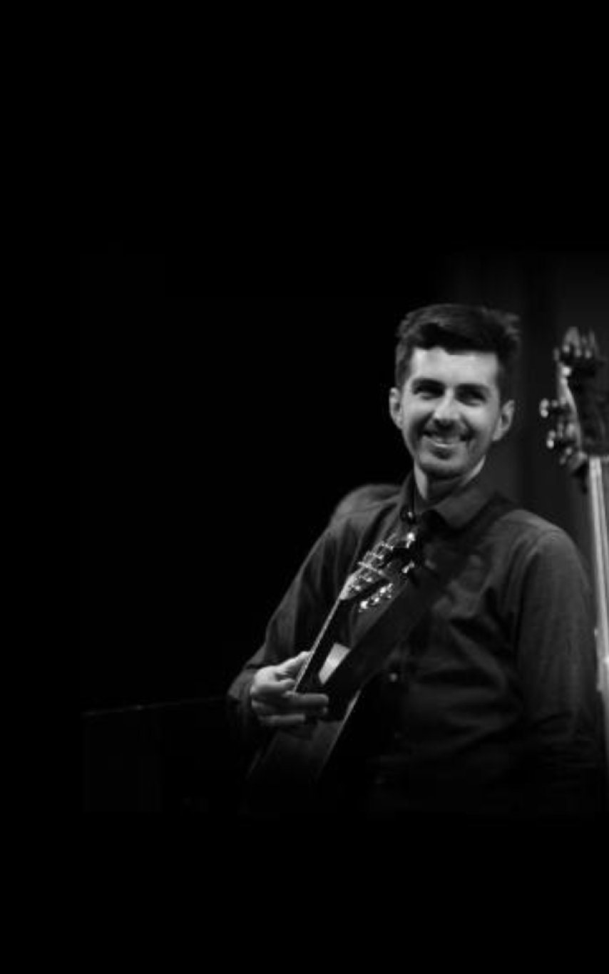 Young man with a guitar and another stringed instrument.